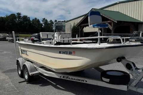 Slide: The Image of 2006 Carolina Skiff 178 DLX boat on EZ Loader trailer, parked outdoors. - 1