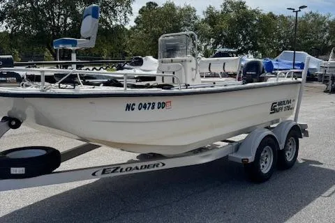Slide: The Image of 2006 Carolina Skiff 178 DLX boat on EZ Loader trailer in parking lot. - 3