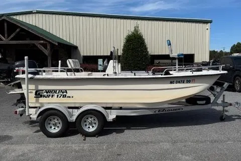 Slide: The Image of 2006 Carolina Skiff 178 DLX boat on trailer, parked outdoors. - 4