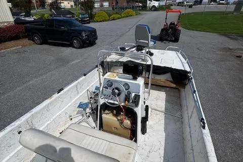 Slide: The Image of 2006 Carolina Skiff 178 DLX boat with console, parked on pavement. - 7