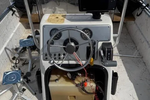 Slide: The Image of 2006 Carolina Skiff 178 DLX boat dashboard with steering wheel and gauges. - 8
