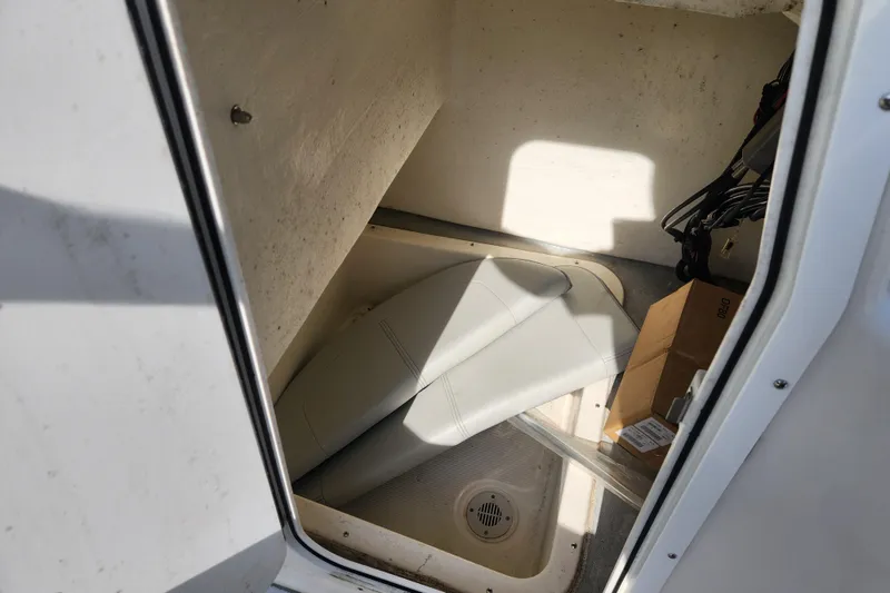 Slide: The Image of Storage compartment of 2023 May-Craft 20 Cape Classic boat with seat cushion and box. - 11