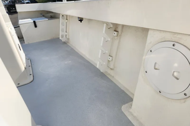 Slide: The Image of 2023 May-Craft 20 Cape Classic boat interior, featuring clean deck and storage compartments. - 12