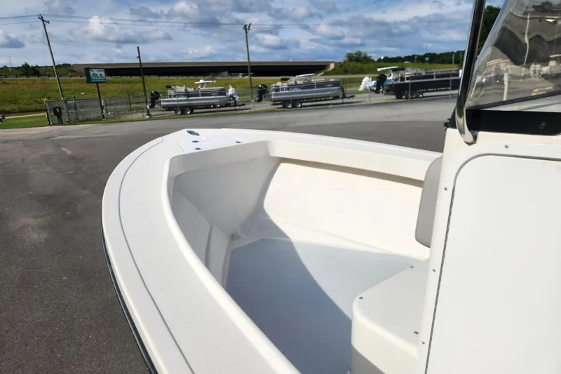 Slide: The Image of 2023 May-Craft 20 Cape Classic boat, white interior, parked outdoors under a cloudy sky. - 8