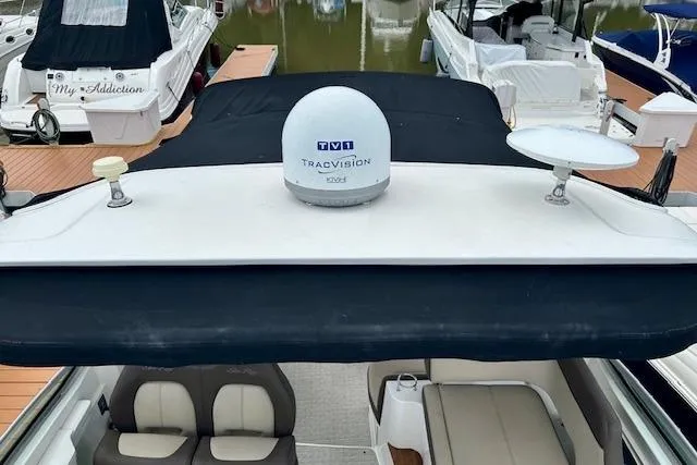 Slide: The Image of 2014 Sea Ray 350 Sundancer with TracVision satellite, docked among other boats. - 11