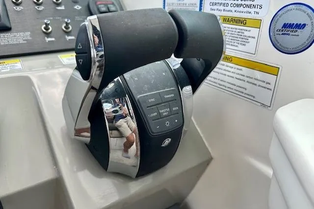 Slide: The Image of Throttle controls on a 2014 Sea Ray 350 Sundancer boat dashboard. - 13