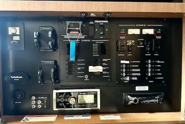 Slide: The Image of Control panel of a 2014 Sea Ray 350 Sundancer boat with various switches and gauges. - 15