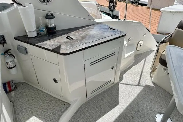 Slide: The Image of Interior view of 2014 Sea Ray 350 Sundancer boat with storage cabinet and countertop. - 6