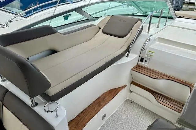 Slide: The Image of 2014 Sea Ray 350 Sundancer interior with cushioned seating and wooden steps. - 7