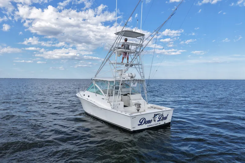 Slide: The Image of 2001 Cabo 35 Express boat on open water under a blue sky. - 2