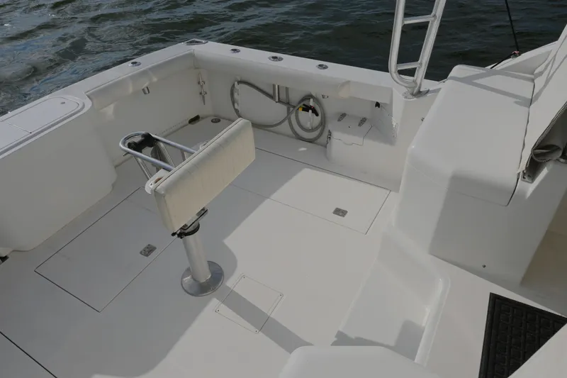Slide: The Image of 2001 Cabo 35 Express boat deck with seating and fishing rod holders. - 21