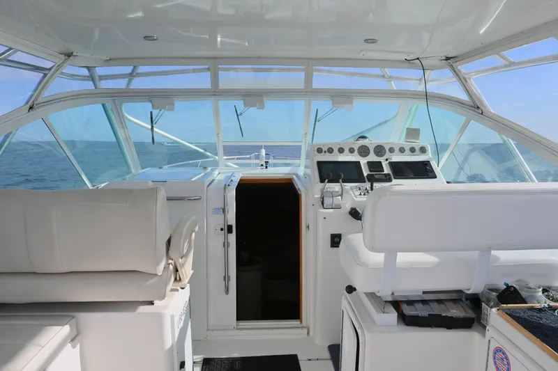 Slide: The Image of Interior view of 2001 Cabo 35 Express boat cockpit with navigation controls. - 24