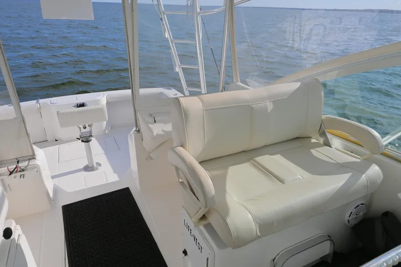 Slide: The Image of 2001 Cabo 35 Express boat interior with white seating and ocean view. - 32