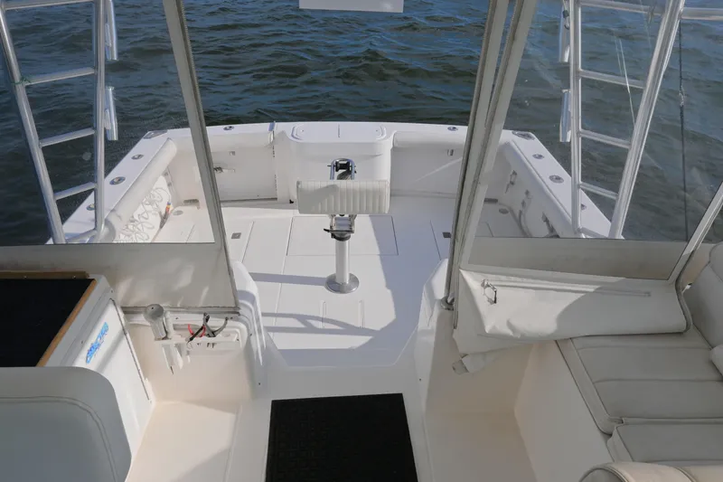 Slide: The Image of 2001 Cabo 35 Express boat interior with seating and fishing rod holders. - 33