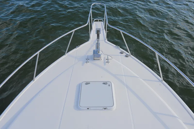 Slide: The Image of Bow view of 2001 Cabo 35 Express boat on water. - 40