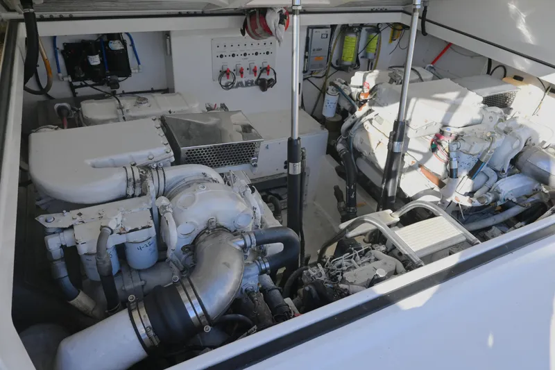 Slide: The Image of Engine room of a 2001 Cabo 35 Express boat, showcasing dual engines and mechanical components. - 54