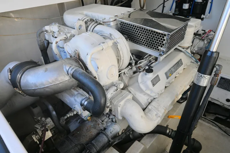 Slide: The Image of Engine room of a 2001 Cabo 35 Express boat, featuring a Caterpillar engine. - 55