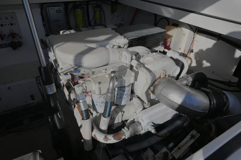 Slide: The Image of Engine compartment of a 2001 Cabo 35 Express boat, showcasing mechanical components. - 56