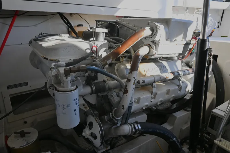 Slide: The Image of Engine compartment of a 2001 Cabo 35 Express boat, showcasing mechanical components. - 58