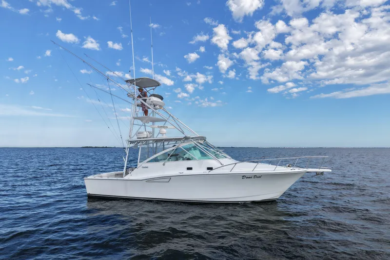 Slide: The Image of 2001 Cabo 35 Express boat on open water under a partly cloudy sky. - 6