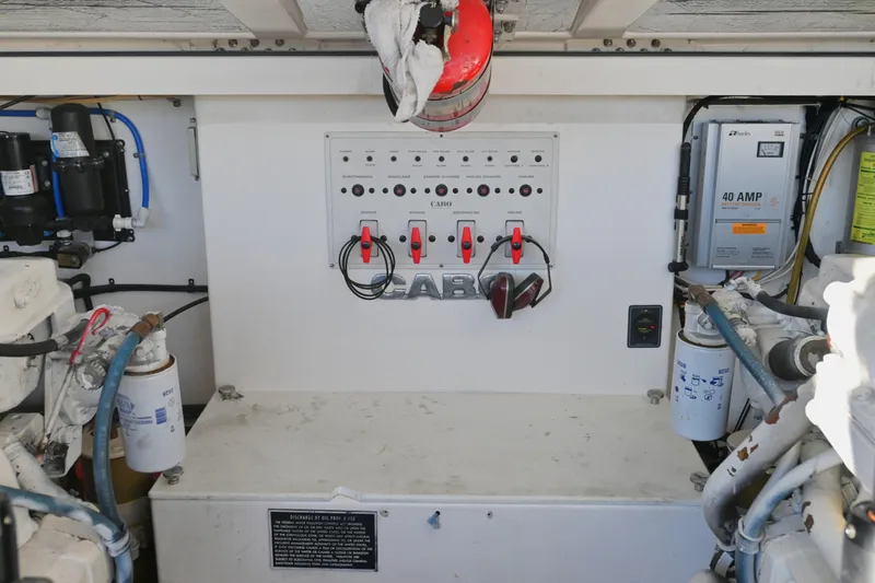 Slide: The Image of Engine room of 2001 Cabo 35 Express boat with control panel and equipment. - 60