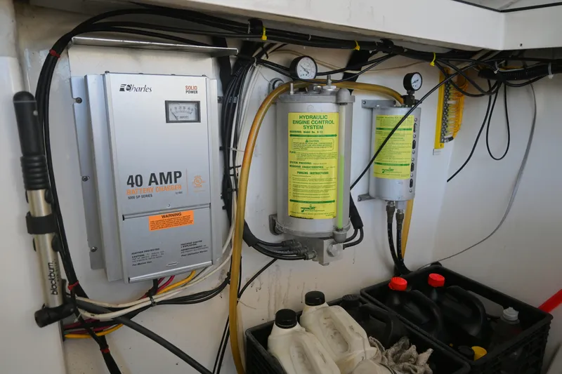 Slide: The Image of 2001 Cabo 35 Express engine room with battery charger and hydraulic control system. - 61