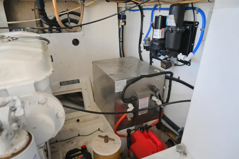 Slide: The Image of Engine room of 2001 Cabo 35 Express boat with mechanical components and wiring. - 62