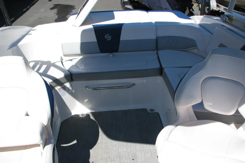 Slide: The Image of Interior seating of 2020 Chaparral 23 Surf boat, featuring white and gray upholstery. - 10