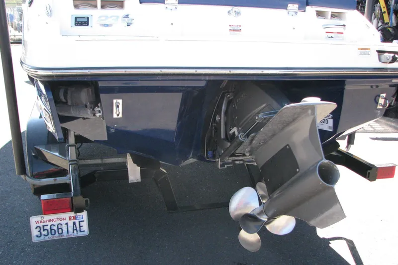 Slide: The Image of 2020 Chaparral 23 Surf boat rear view with propeller and Washington license plate. - 14