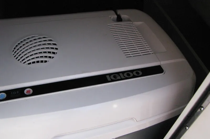 Slide: The Image of Igloo cooler inside 2020 Chaparral 23 Surf boat storage compartment. - 5