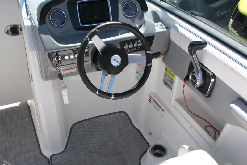 Slide: The Image of 2020 Chaparral 23 Surf boat cockpit with steering wheel and control panel. - 6
