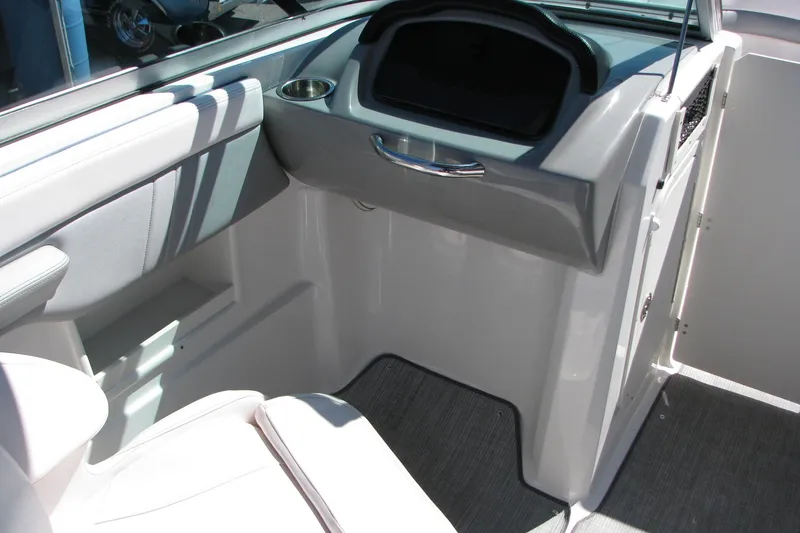 Slide: The Image of 2020 Chaparral 23 Surf boat interior with sleek seating and modern dashboard design. - 8