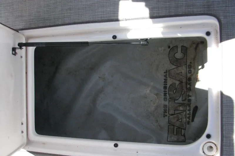 Slide: The Image of Open storage compartment with FatSac ballast bag in 2020 Chaparral 23 Surf boat. - 9