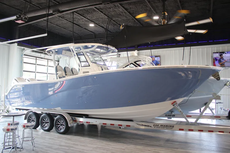 The Image of 2026 Sea Fox 328 Commander boat in showroom, blue hull, on trailer. - 0