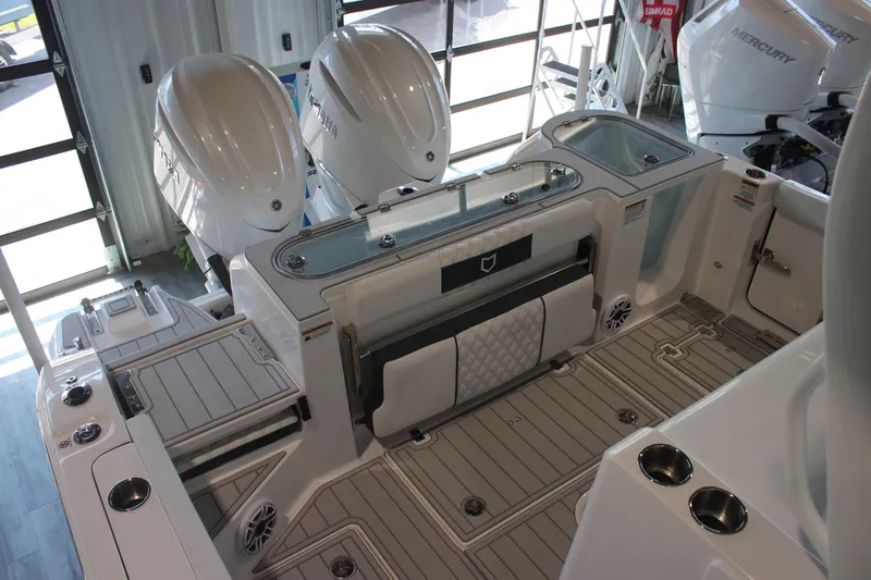 Slide: The Image of 2026 Sea Fox 328 Commander boat interior with cushioned seating and control panel. - 25