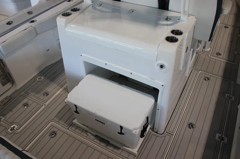 Slide: The Image of 2026 Sea Fox 328 Commander boat interior with open storage compartment and cup holders. - 33