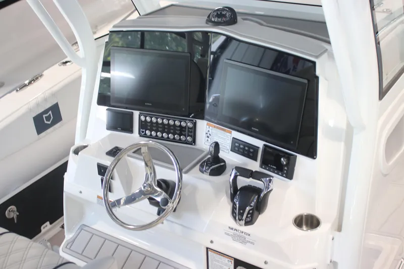 Slide: The Image of 2026 Sea Fox 328 Commander boat anchor compartment with open hatch, showcasing storage space. - 4
