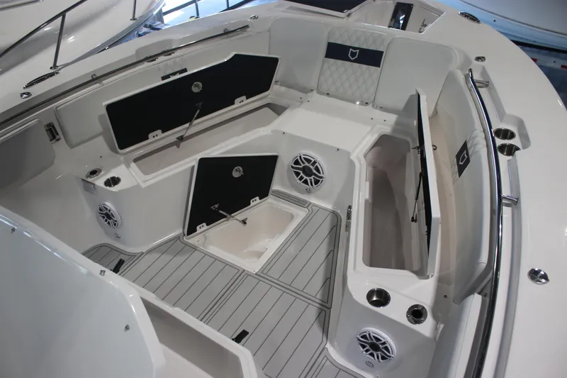Slide: The Image of 2026 Sea Fox 328 Commander boat storage compartments with open lids and cup holders. - 5