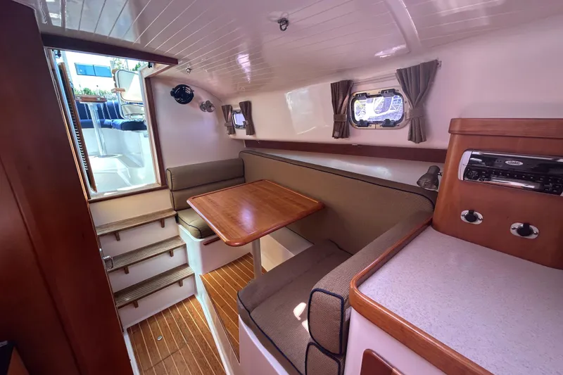 Slide: The Image of 2005 Hunt Yachts Surfhunter 33 interior with striped seating and American flag. - 11