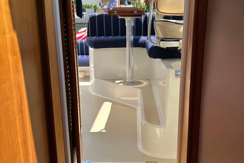 Slide: The Image of 2005 Hunt Yachts Surfhunter 33 interior with blue seating and wooden accents. - 20