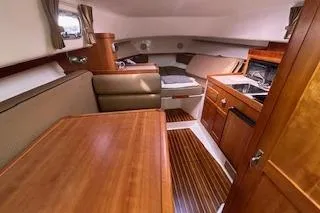 Slide: The Image of 2005 Hunt Yachts Surfhunter 33 interior with wood finishes and cozy seating area. - 22