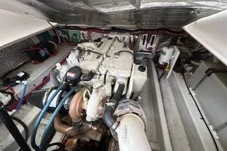 Slide: The Image of Engine compartment of 2005 Hunt Yachts Surfhunter 33, showcasing mechanical components and wiring. - 25