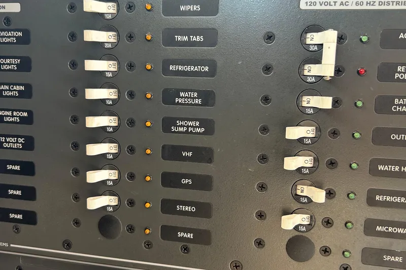 Slide: The Image of Electrical panel of 2005 Hunt Yachts Surfhunter 33 with labeled switches and indicators. - 26