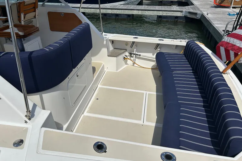 Slide: The Image of 2005 Hunt Yachts Surfhunter 33 cockpit with blue striped seating at dock. - 3