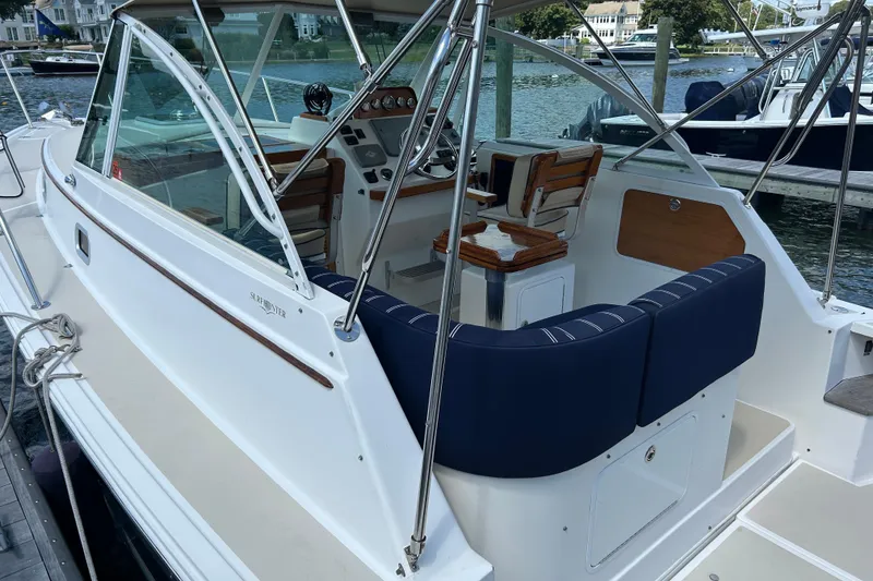 Slide: The Image of 2005 Hunt Yachts Surfhunter 33 docked, featuring a sleek design and American flag. - 4