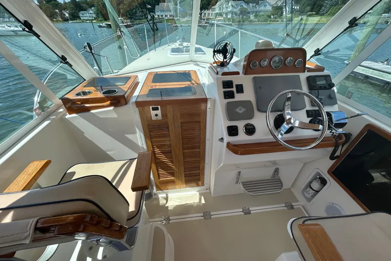 Slide: The Image of 2005 Hunt Yachts Surfhunter 33 docked in a scenic waterfront setting. - 7