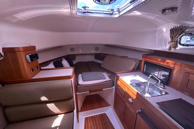 Slide: The Image of 2005 Hunt Yachts Surfhunter 33 helm with wooden cabinetry and navigational controls. - 9