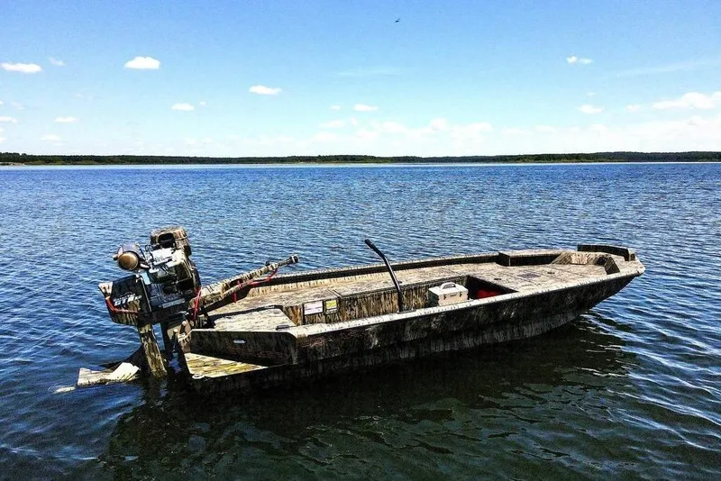 The Image of 2026 SeaArk 1752 Slayer X Pro boat with camouflage design on a trailer. - 0