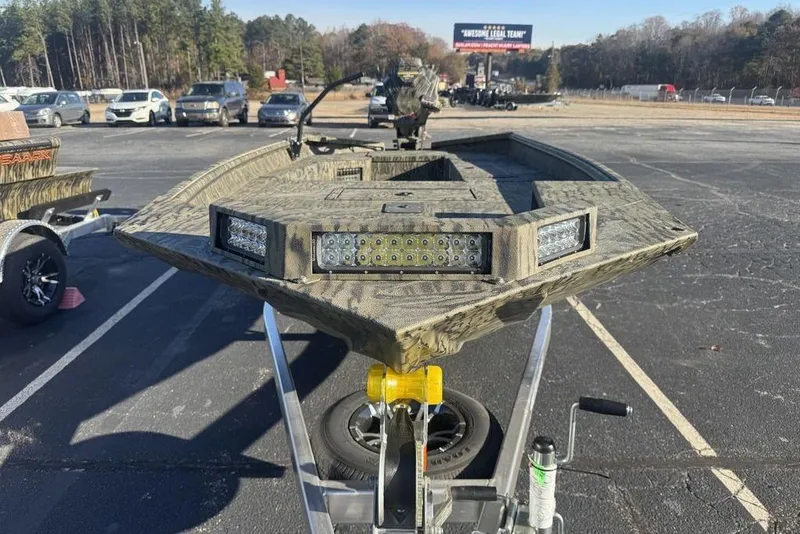 Slide: The Image of 2026 SeaArk 1752 Slayer X Pro boat on trailer in parking lot. - 6