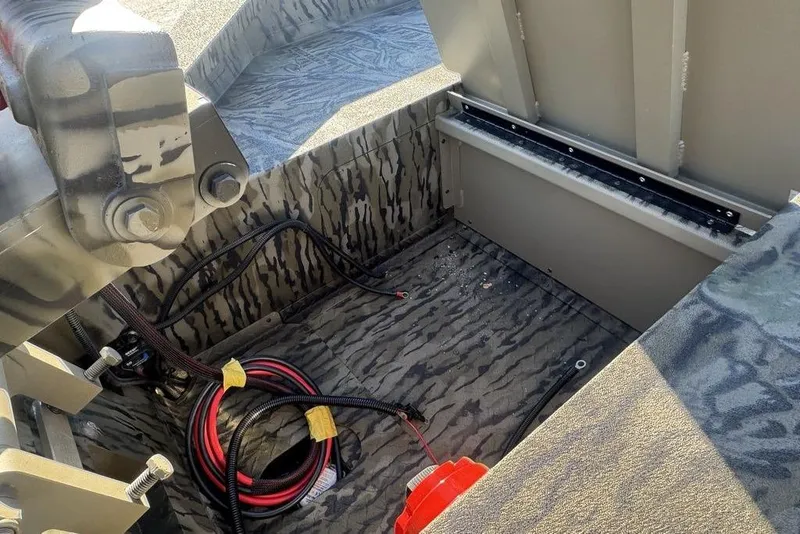 Slide: The Image of Interior view of 2026 SeaArk 1752 Slayer X Pro boat with wiring and storage compartment. - 8